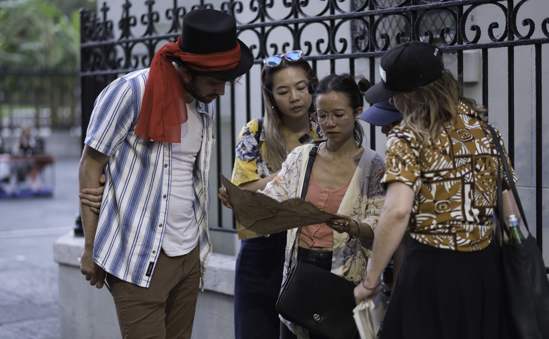 Group of friends in the French Quarter looking at a vintage street map