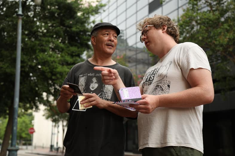 Two players comparing clues on a city street